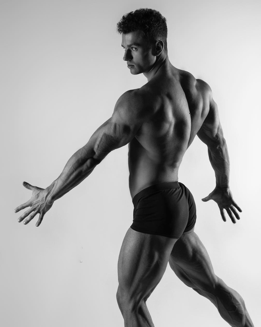 Vlad Lapshin practicing posing while being shirtless, revealing his muscular and lean body