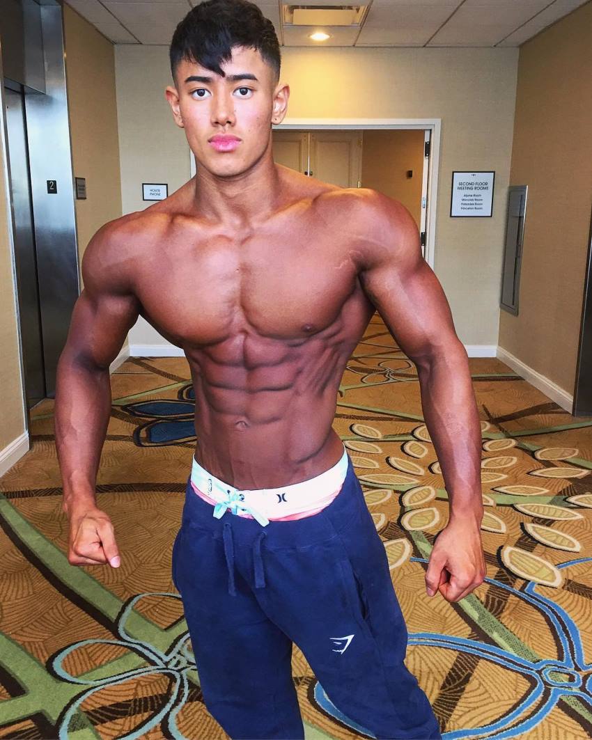 Steven Cao posing tanned up in a hotel lobby
