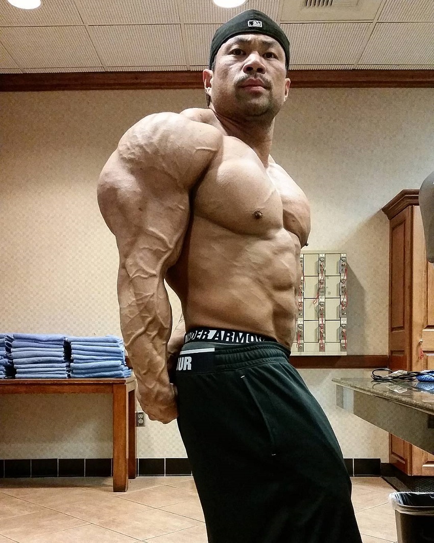 Premium Photo | Handsome bodybuilder making side triceps pose
