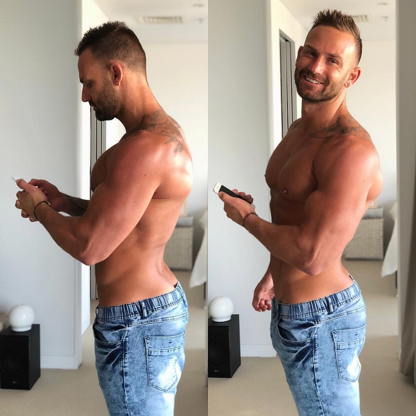 Joel Bushby posing for a photo showing his body from the side